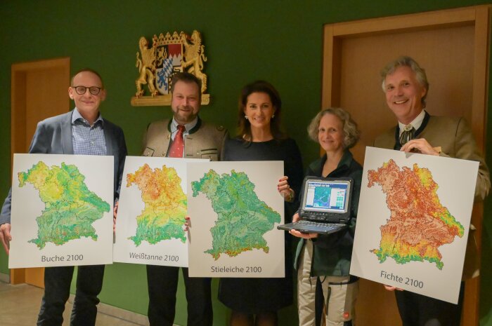 Die Ministerin mit vier weiteren Personen nebeneinander, alle halten Grafikkarten in den Händen.